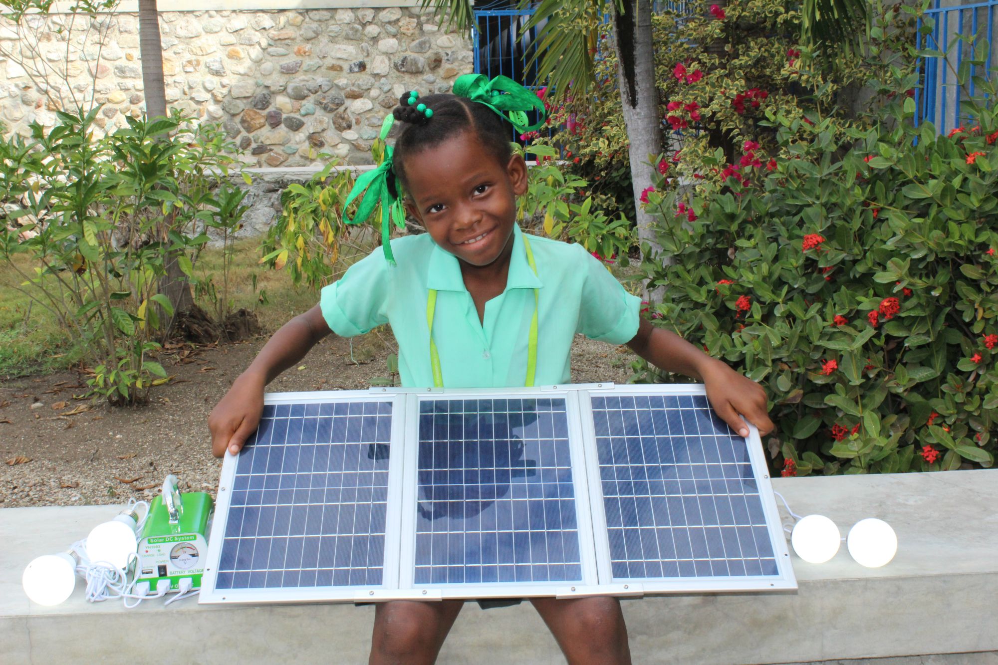 Haitian girl with solar panel gift