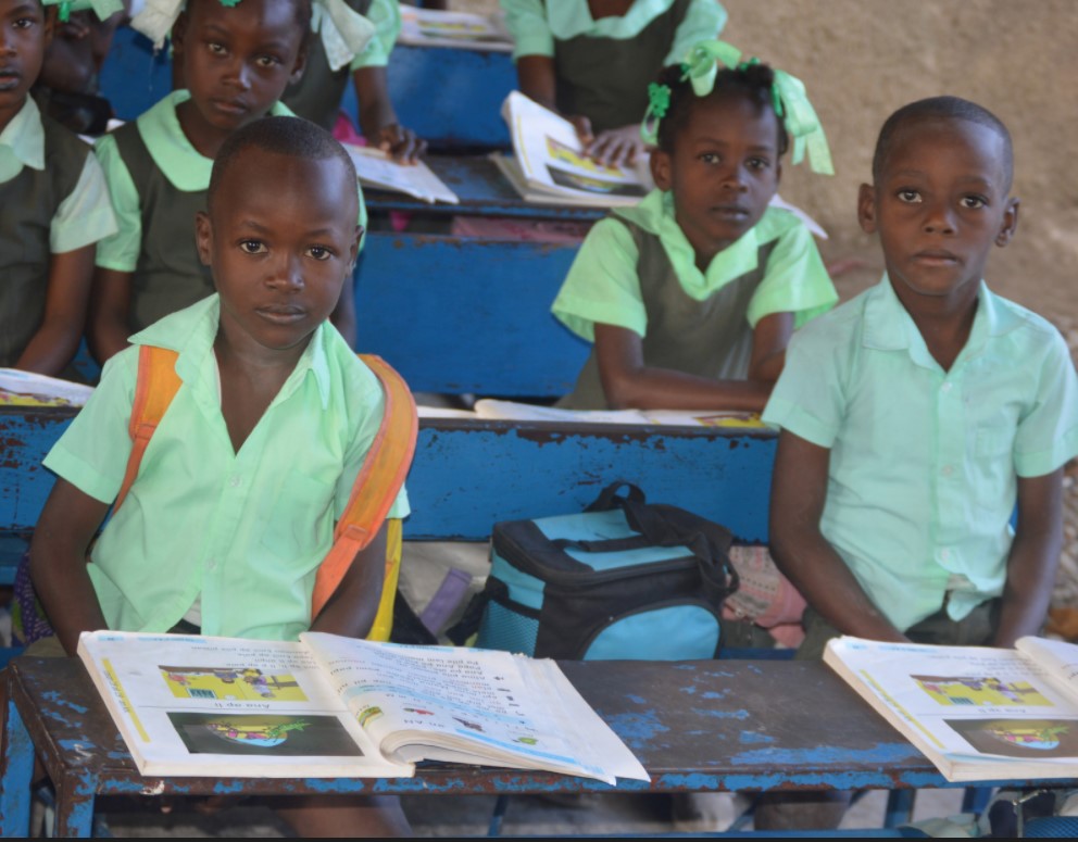 Picture of a few first graders at their desks.
