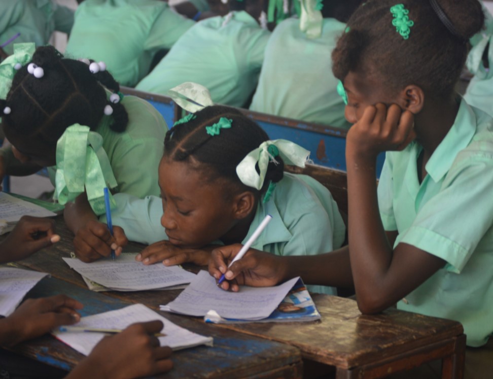 A group of 6th grade students working at their desks.
