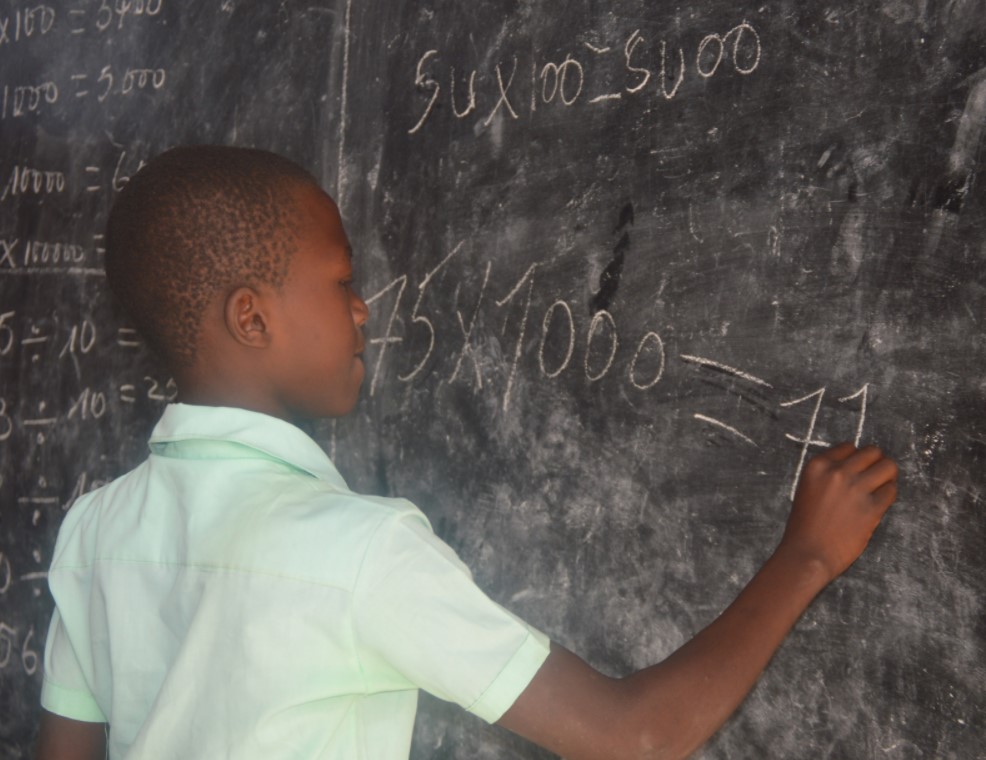 Boy at chalkboard in 5th grade at Vieux-Caille