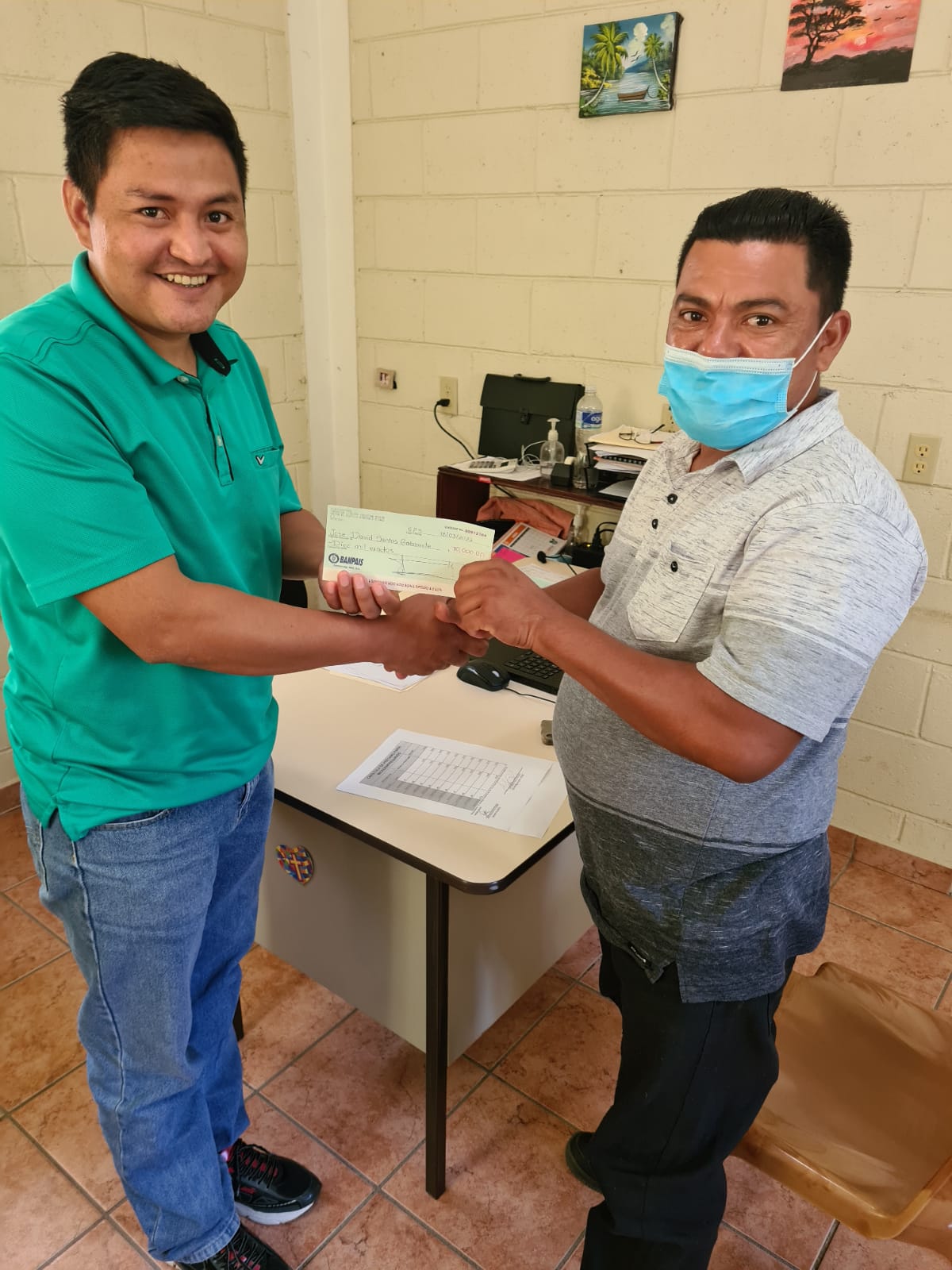 Jose receiving microloan check